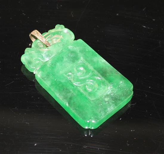 A simulated jade rectangular pendant with yellow metal mount (tests at 9ct gold), carved with scrolling motifs, 54mm,